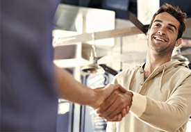 Two people are shaking hands with each other.